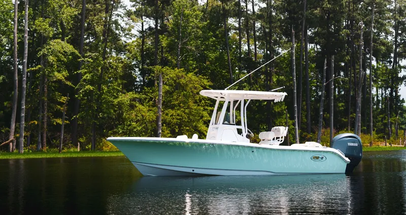 Slide: The Image of Sea Hunt Ultra 219 boat 2027 on a tranquil lake. - 5