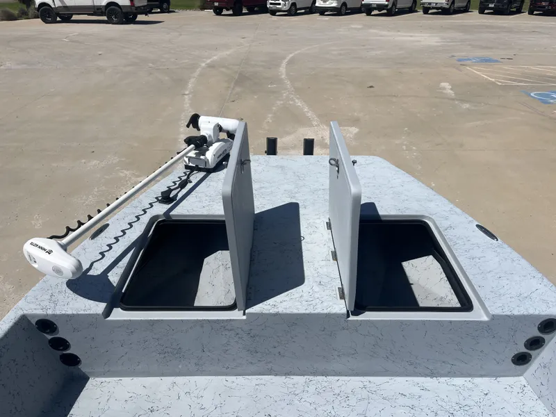 Slide: The Image of 2024 Freedom PATRIOT boat with storage compartments and Minn Kota motor. - 13