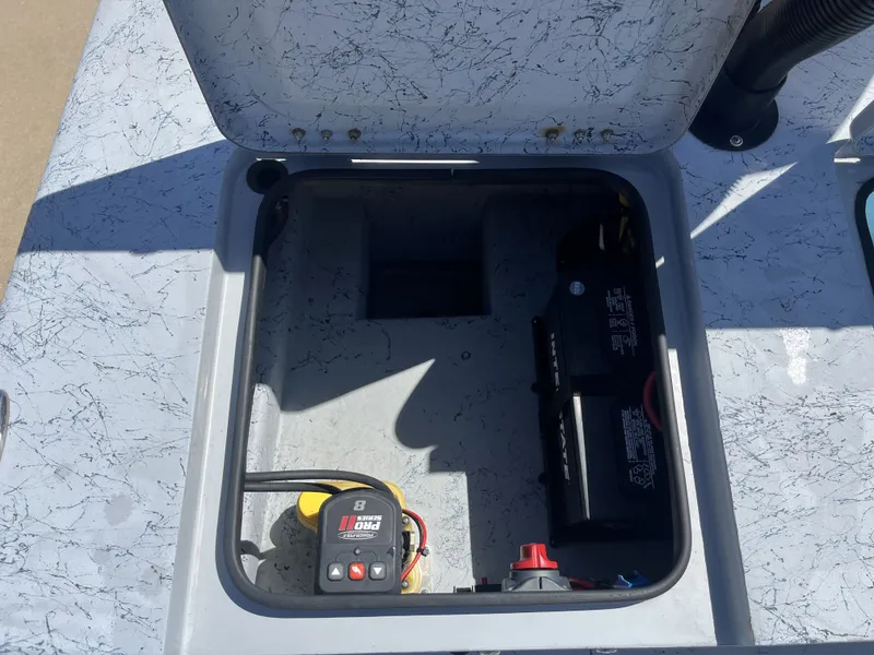 Slide: The Image of Battery compartment of 2024 Freedom PATRIOT boat with charger. - 23