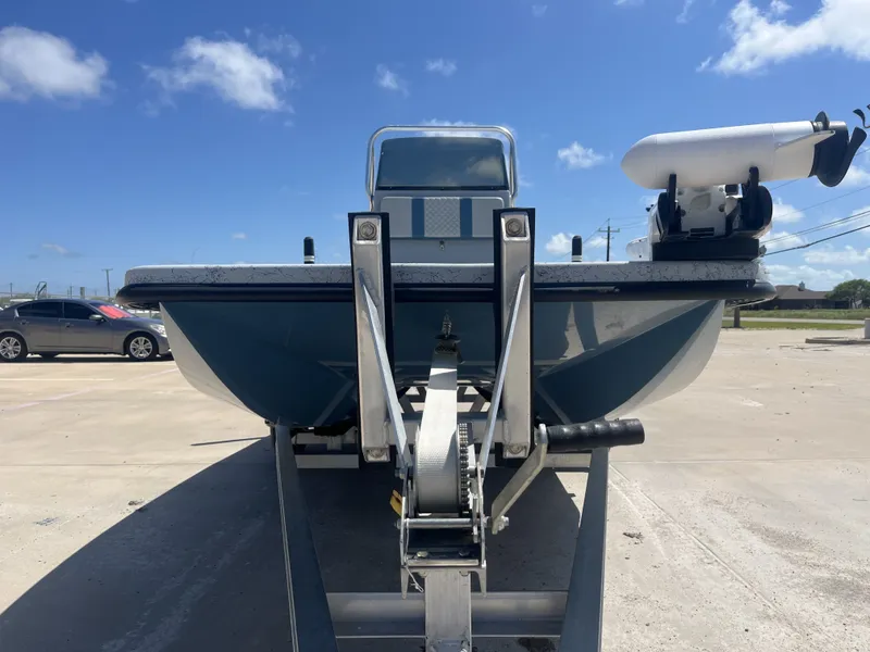 Slide: The Image of 2024 Freedom PATRIOT boat on trailer under sunny skies. - 5