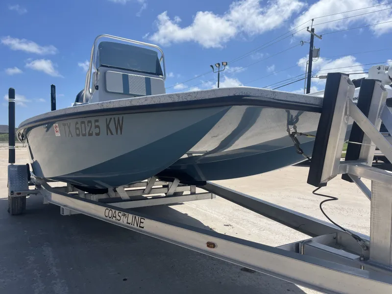 Slide: The Image of 2024 Freedom PATRIOT boat on trailer under sunny skies. - 6
