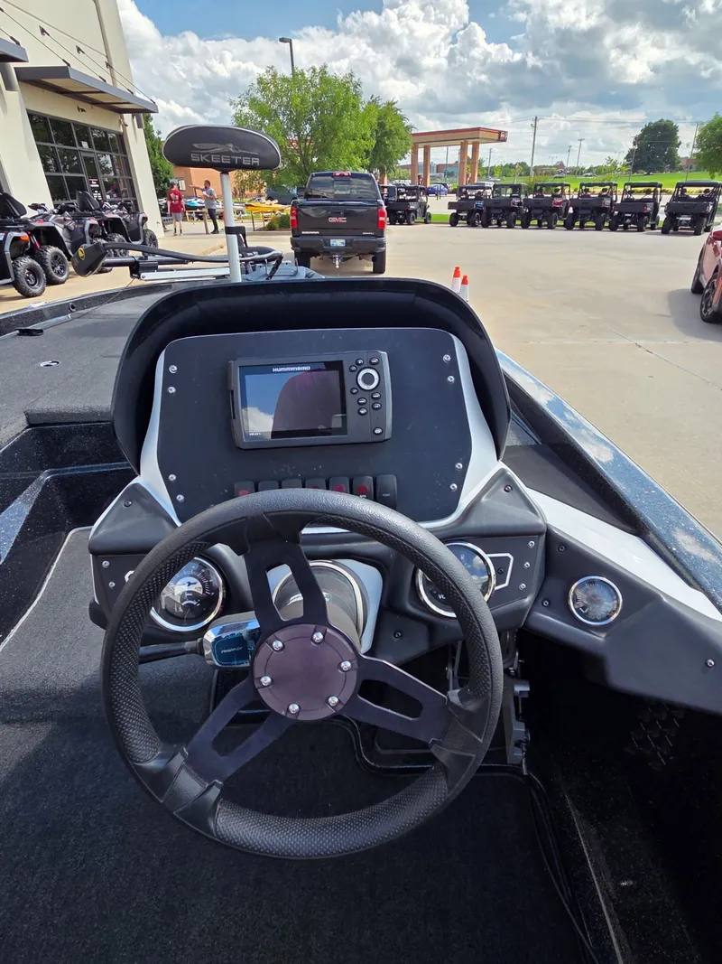 Slide: The Image of Interior view of 2023 Skeeter ZX 150 boat with steering console. - 11