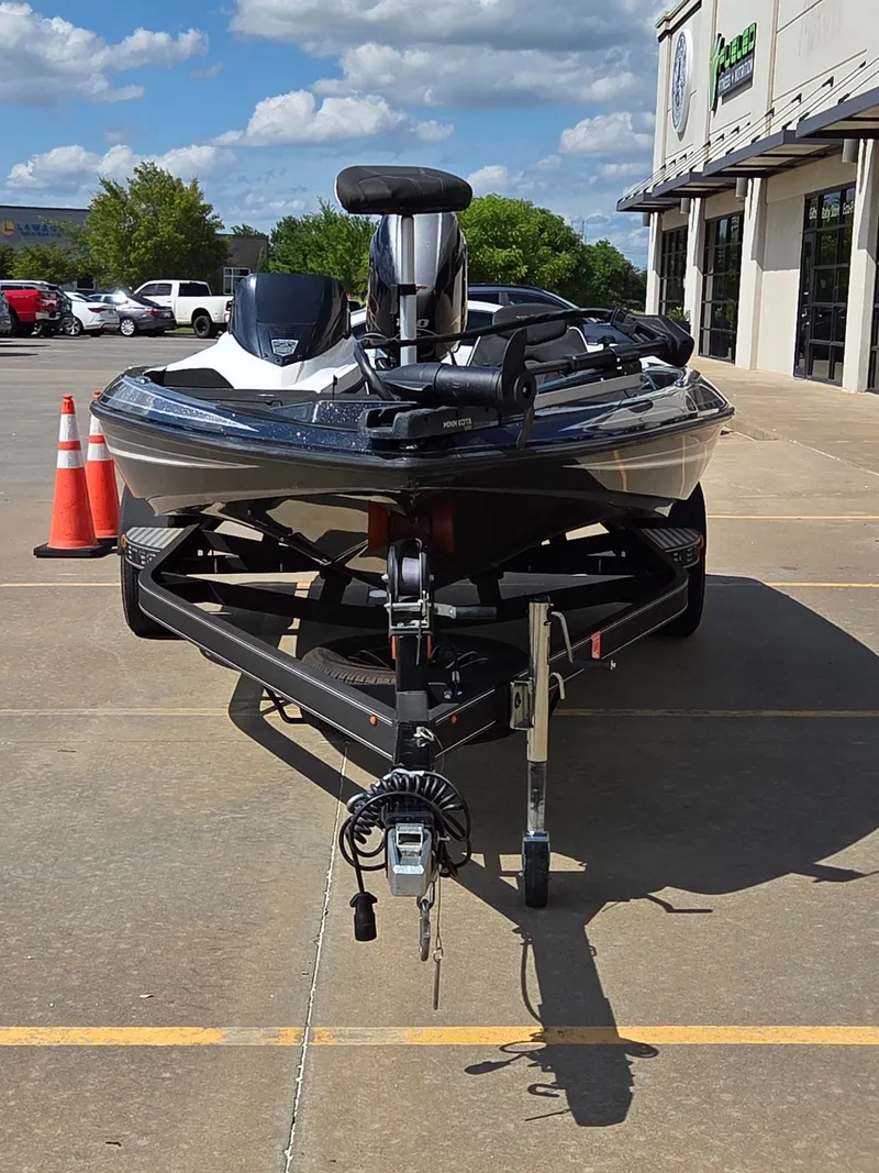 Slide: The Image of 2023 Skeeter ZX 150 boat on trailer in front of building. - 3
