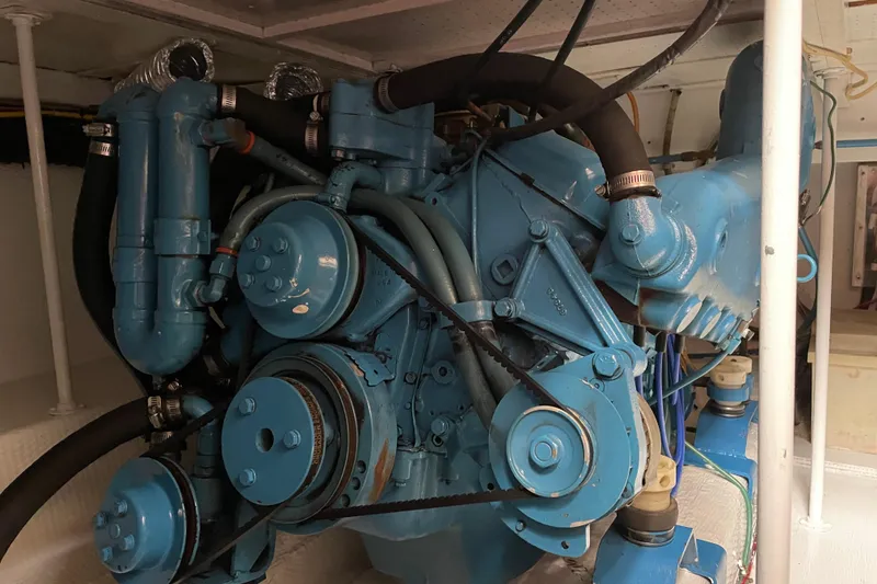 Slide: The Image of Engine of a 1984 Egg Harbor 33 Convertible boat, showcasing intricate mechanical components. - 13