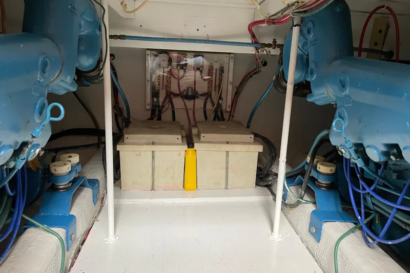 Slide: The Image of Engine room of 1984 Egg Harbor 33 Convertible with visible batteries and wiring. - 14