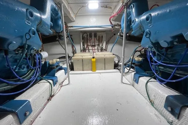 Slide: The Image of Engine room of 1984 Egg Harbor 33 Convertible with dual blue engines and wiring. - 17