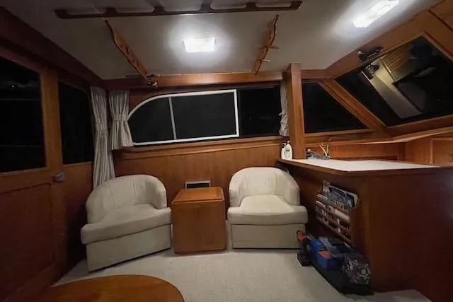 Slide: The Image of Interior of 1984 Egg Harbor 33 Convertible yacht with cozy seating and wooden accents. - 19
