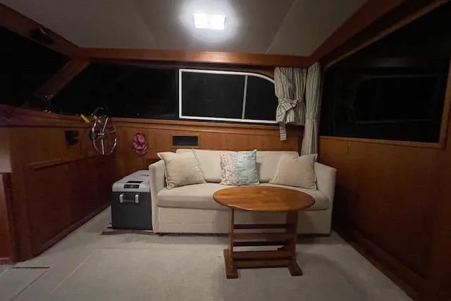 Slide: The Image of Interior of 1984 Egg Harbor 33 Convertible yacht with cozy seating and wooden accents. - 20