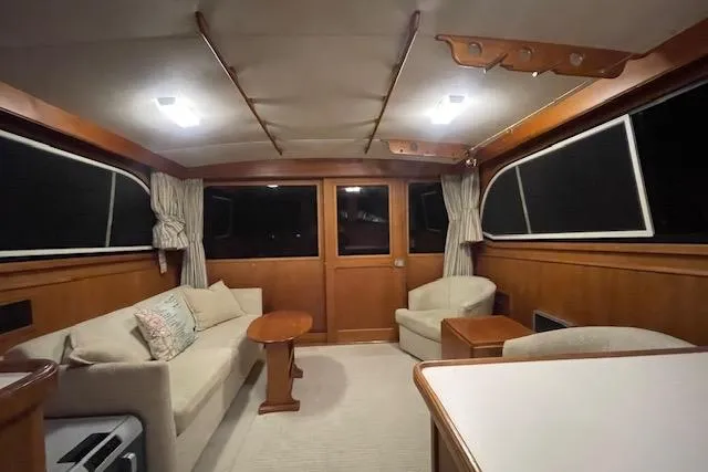 Slide: The Image of Interior of a 1984 Egg Harbor 33 Convertible yacht, featuring cozy seating and wooden accents. - 21