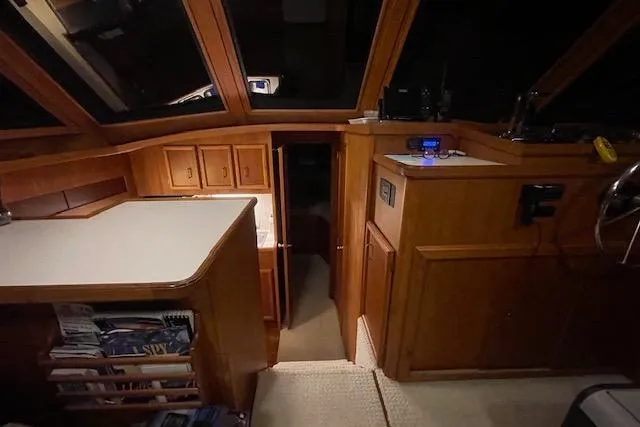Slide: The Image of Interior of a 1984 Egg Harbor 33 Convertible boat with wooden cabinetry and helm station. - 22