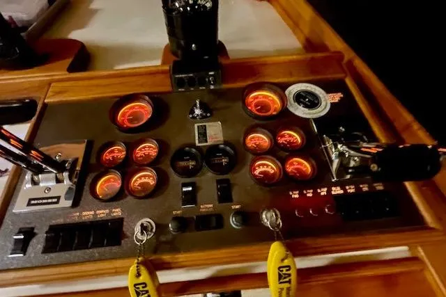 Slide: The Image of Control panel of a 1984 Egg Harbor 33 Convertible boat with illuminated gauges. - 23