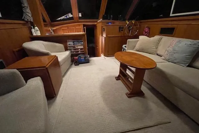 Slide: The Image of Interior of 1984 Egg Harbor 33 Convertible yacht with cozy seating and wooden accents. - 24