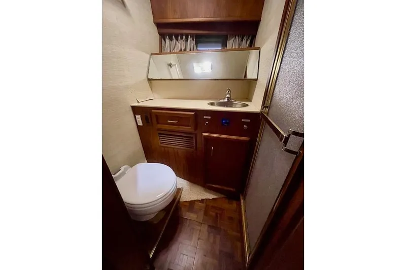 Slide: The Image of 1984 Egg Harbor 33 Convertible yacht bathroom with sink, toilet, and shower. - 25