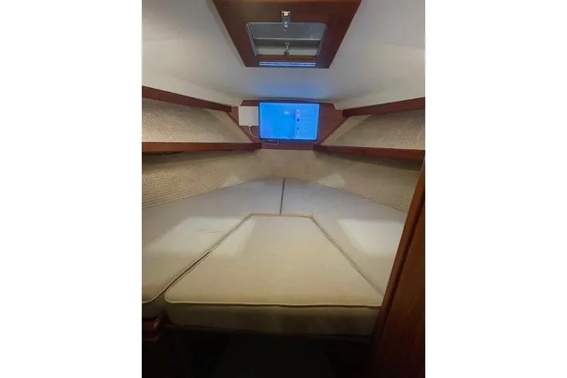 Slide: The Image of Interior cabin of 1984 Egg Harbor 33 Convertible yacht with cozy bedding. - 29