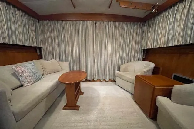Slide: The Image of Interior of 1984 Egg Harbor 33 Convertible yacht with cozy seating and wooden accents. - 32