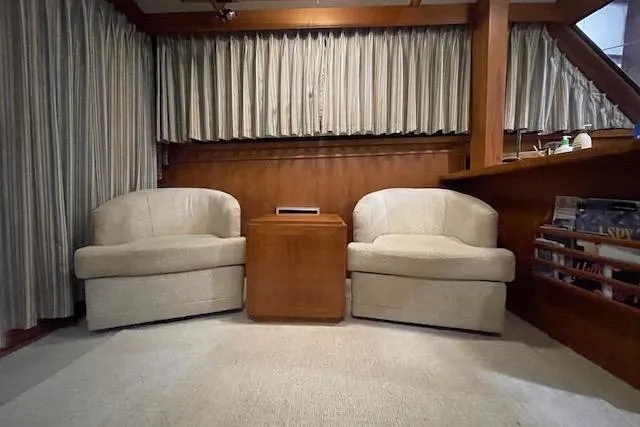 Slide: The Image of Interior of 1984 Egg Harbor 33 Convertible yacht with beige chairs and wooden accents. - 33