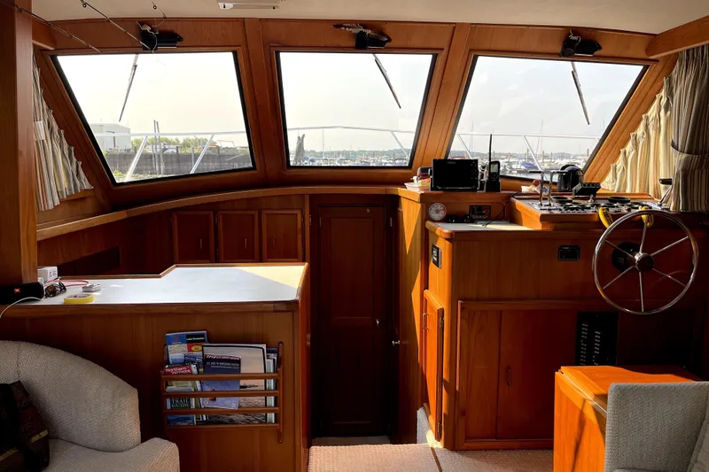 Slide: The Image of Interior of a 1984 Egg Harbor 33 Convertible yacht with wooden cabinetry and helm. - 35