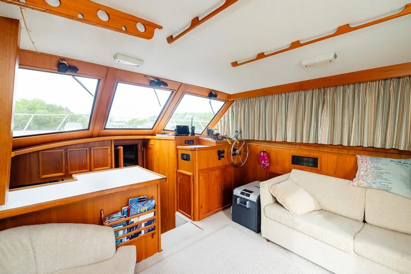 Slide: The Image of Interior of 1984 Egg Harbor 33 Convertible yacht with wood paneling and cozy seating. - 44