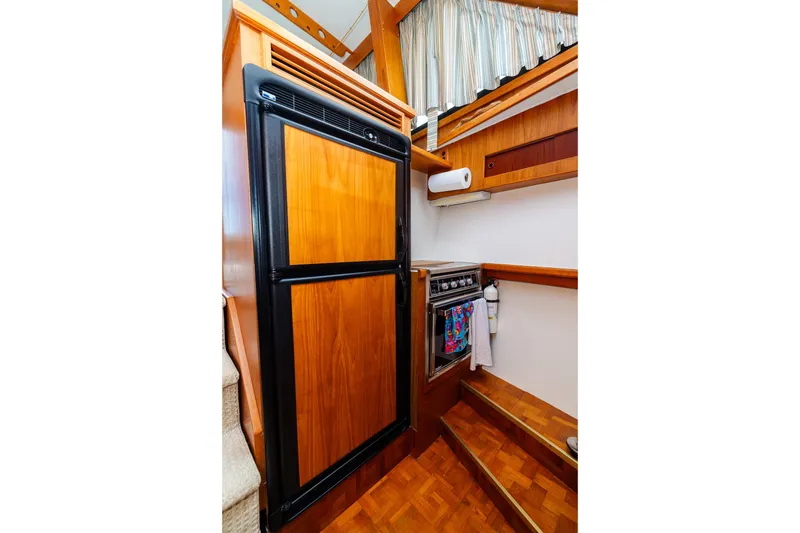 Slide: The Image of 1984 Egg Harbor 33 Convertible yacht kitchen with wood cabinetry and appliances. - 46