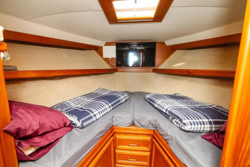 Slide: The Image of Cozy cabin interior of 1984 Egg Harbor 33 Convertible with twin beds and wood accents. - 47