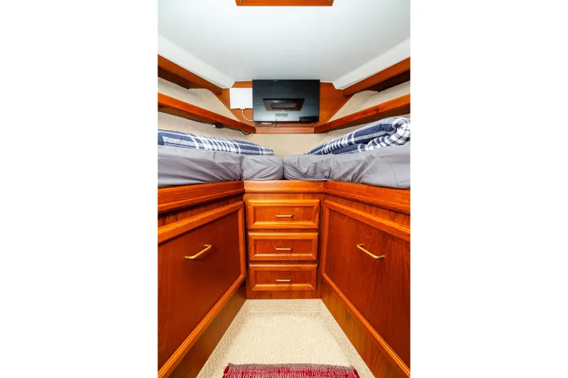 Slide: The Image of 1984 Egg Harbor 33 Convertible cabin with wooden cabinetry and twin beds. - 48