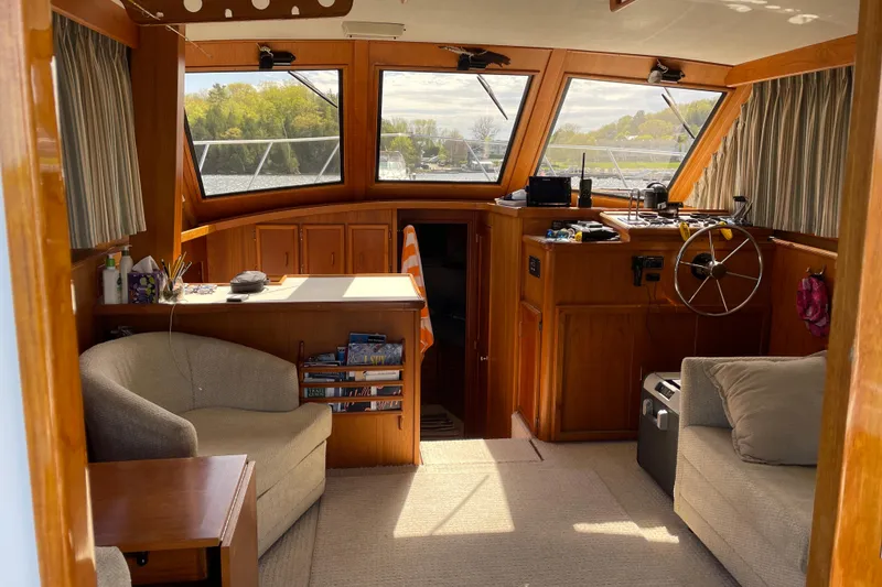 Slide: The Image of Interior of a 1984 Egg Harbor 33 Convertible boat with wooden furnishings and large windows. - 5