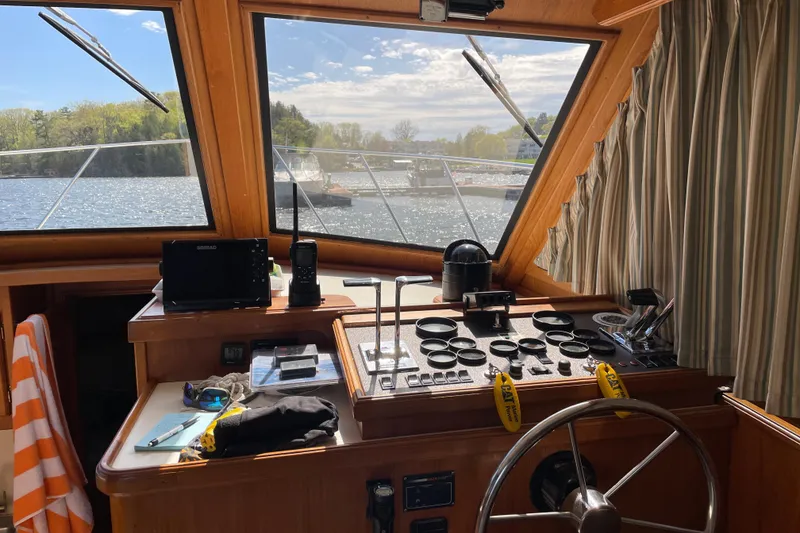 Slide: The Image of Interior view of 1984 Egg Harbor 33 Convertible boat cockpit with steering wheel and navigation equipment. - 6