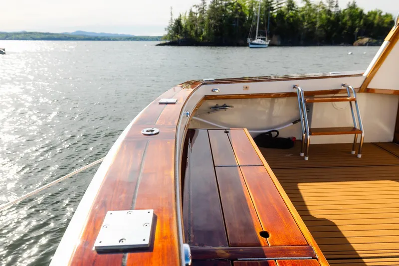 Slide: The Image of 1984 Egg Harbor 33 Convertible yacht deck with polished wood finish, overlooking serene waters. - 63