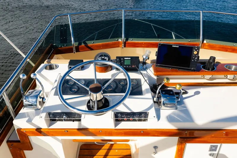 Slide: The Image of Helm of 1984 Egg Harbor 33 Convertible boat with steering wheel and navigation equipment. - 64