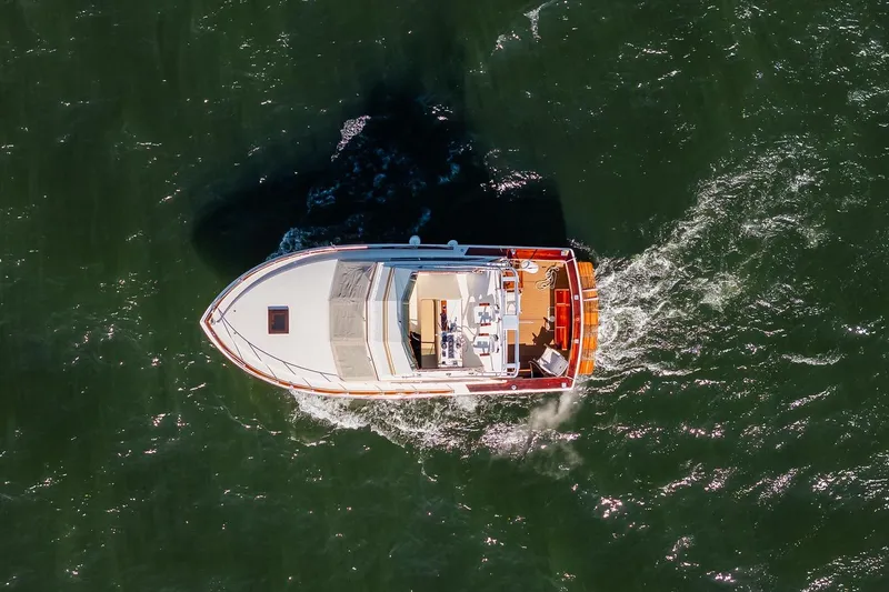 Slide: The Image of Aerial view of 1984 Egg Harbor 33 Convertible boat cruising on open water. - 69