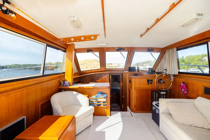 Slide: The Image of Interior of 1984 Egg Harbor 33 Convertible yacht with wood paneling and comfortable seating. - 71