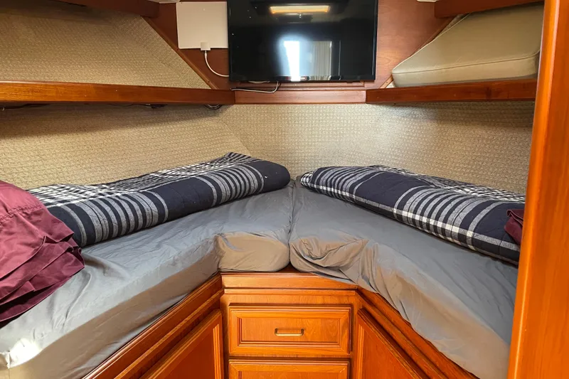 Slide: The Image of Cozy cabin interior of 1984 Egg Harbor 33 Convertible with twin beds and TV. - 8