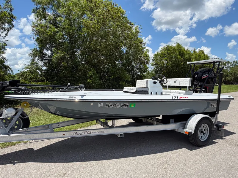 The Image of 1997 Back Country 171 Pro Guide boat on trailer, sunny day. - 0