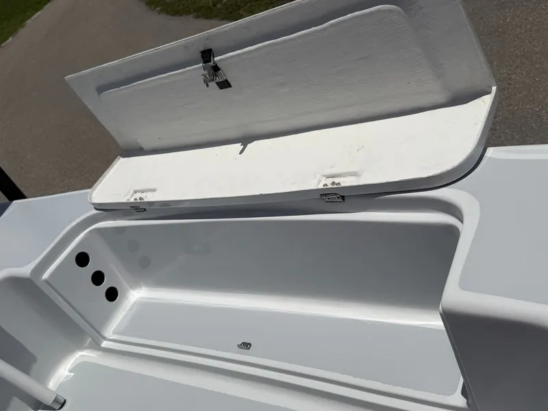 Slide: The Image of Open storage compartment on a 1997 Back Country 171 Pro Guide boat. - 13