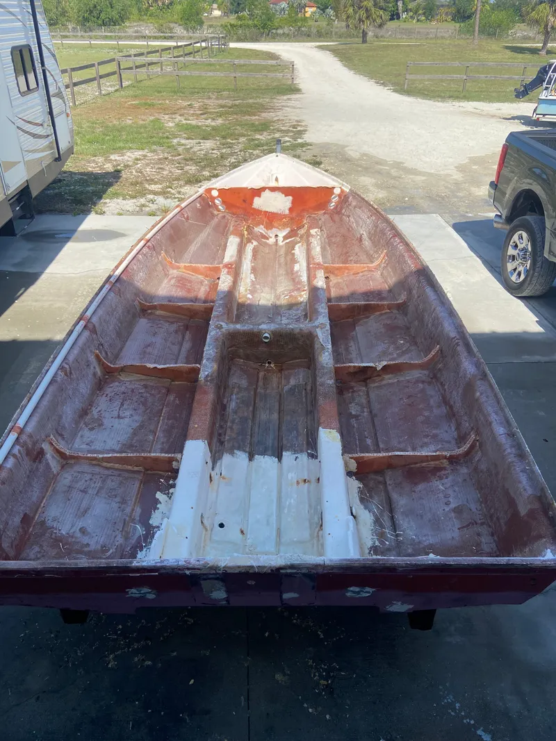 Slide: The Image of A 1997 Back Country 171 Pro Guide boat with unfinished interior, parked in a yard. - 27