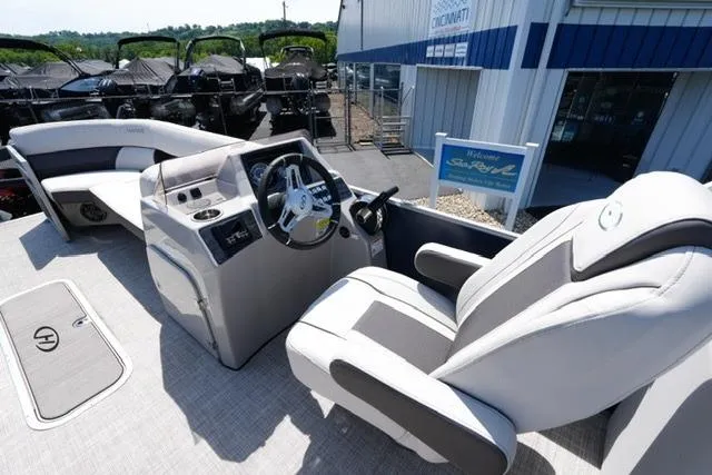 Slide: The Image of 2023 Harris Cruiser 230 CW boat interior with modern helm and seating. - 10