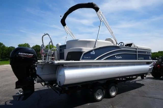 Slide: The Image of 2023 Harris Cruiser 230 CW pontoon boat on trailer, featuring a Mercury outboard motor. - 5