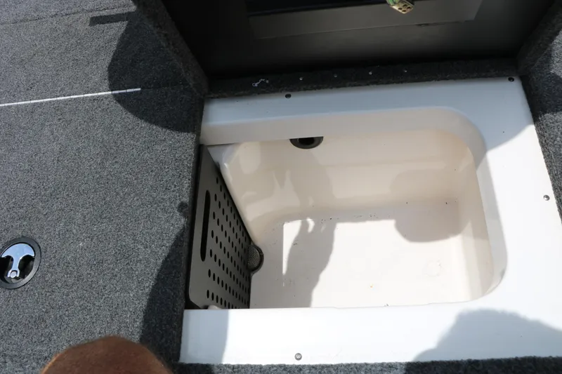 Slide: The Image of Open storage compartment in 2019 Vexus AVX 1980 boat, featuring carpeted flooring and drainage. - 29