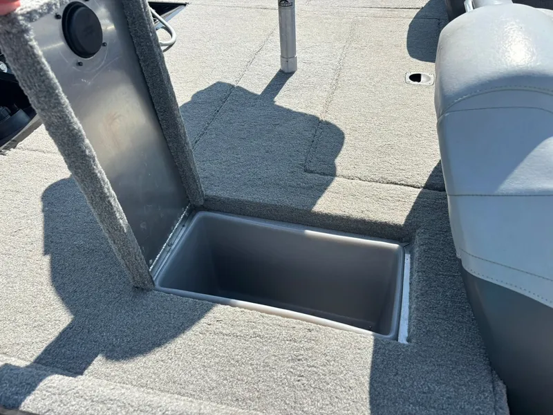 Slide: The Image of 2012 Tracker Pro Team 190 TX boat with open storage compartment. - 13