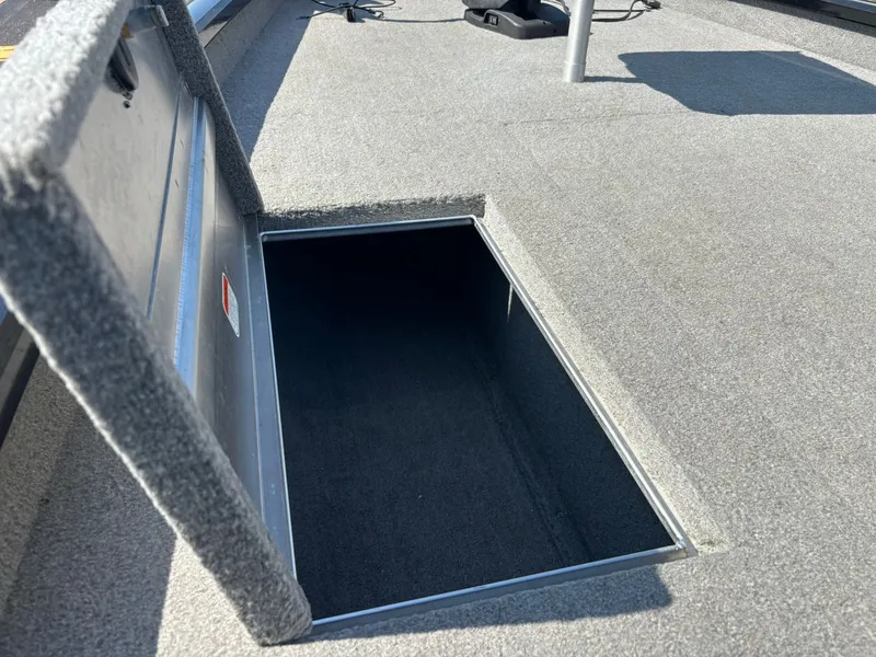 Slide: The Image of Open storage compartment on 2012 Tracker Pro Team 190 TX boat. - 18