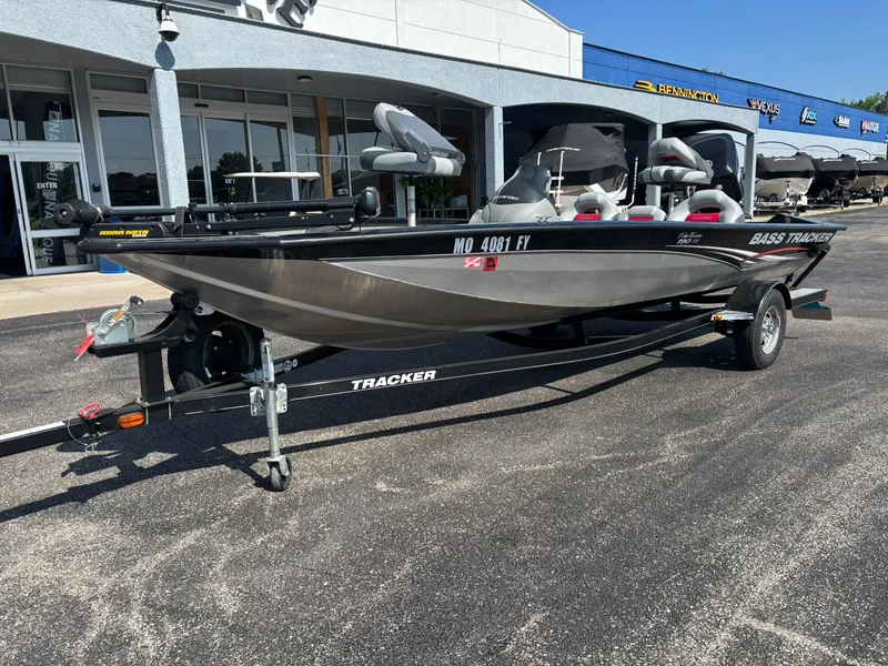 Slide: The Image of 2012 Tracker Pro Team 190 TX boat on trailer outside store. - 25