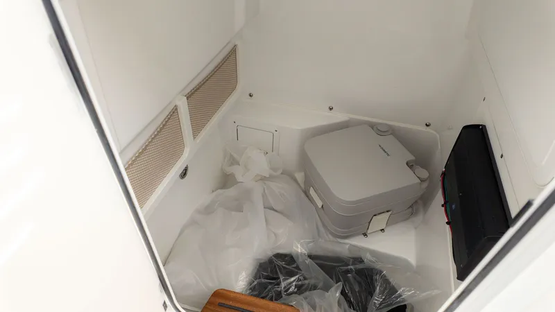 Slide: The Image of Interior of Everglades 253 Center Console 2026 with portable toilet. - 11