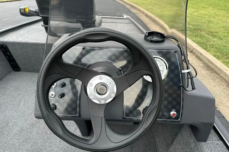 Slide: The Image of Steering wheel of 2026 Tracker Bass Tracker Classic XL boat, featuring modern dashboard design. - 9