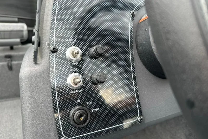 Slide: The Image of Control panel of 2026 Tracker Bass Tracker Classic XL boat with switches and ignition. - 11