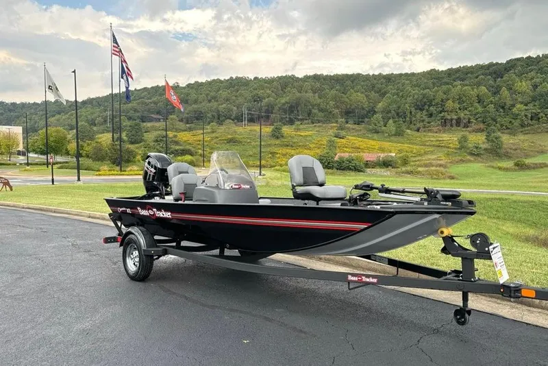 Slide: The Image of 2026 Tracker Bass Tracker Classic XL boat on trailer, parked outdoors with scenic background. - 2