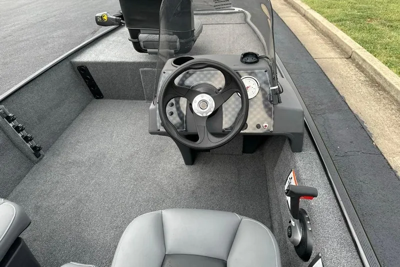 Slide: The Image of 2026 Tracker Bass Tracker Classic XL boat interior with steering wheel and dashboard controls. - 6