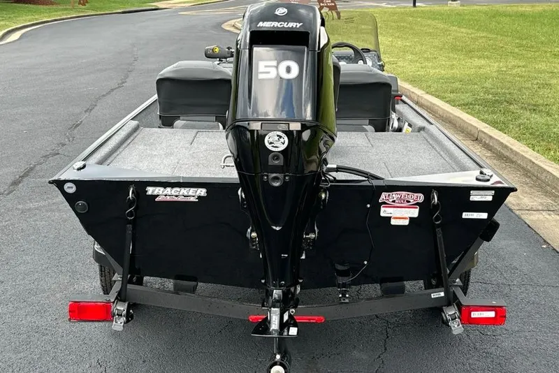 Slide: The Image of 2026 Tracker Bass Tracker Classic XL boat with Mercury 50 engine, parked on asphalt. - 4
