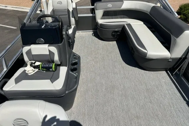 Slide: The Image of 2026 Sun Tracker Bass Buggy 16 XL Select pontoon boat interior with gray seating and carpet. - 15