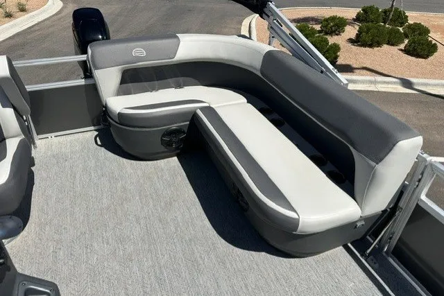 Slide: The Image of 2026 Sun Tracker Bass Buggy 16 XL Select pontoon boat with gray seating and spacious deck. - 16