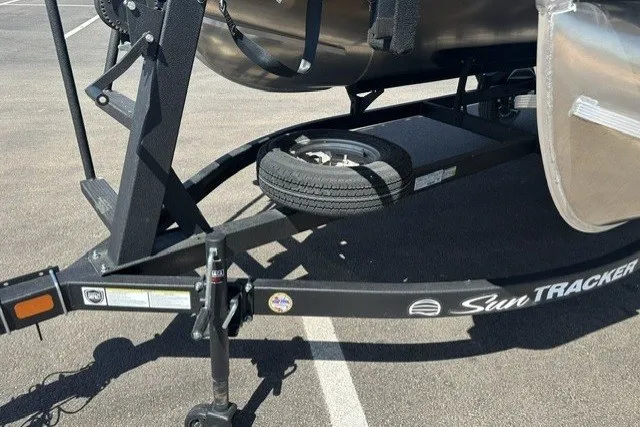 Slide: The Image of Trailer of 2026 Sun Tracker Bass Buggy 16 XL Select with spare tire in parking lot. - 21